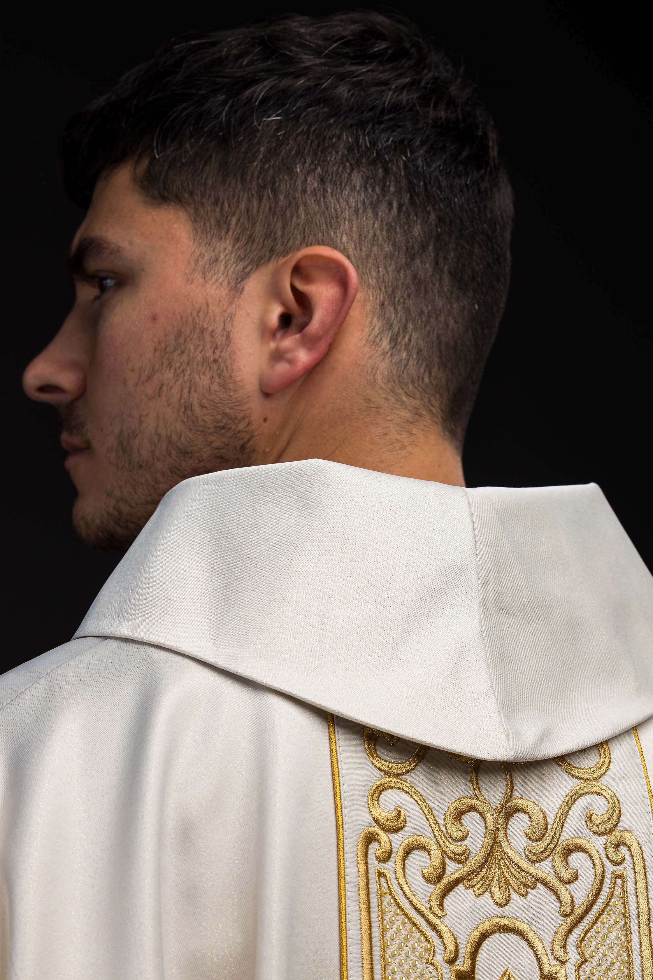 Ornat z połyskującej tkaniny z bogatym złotym haftem na pasie